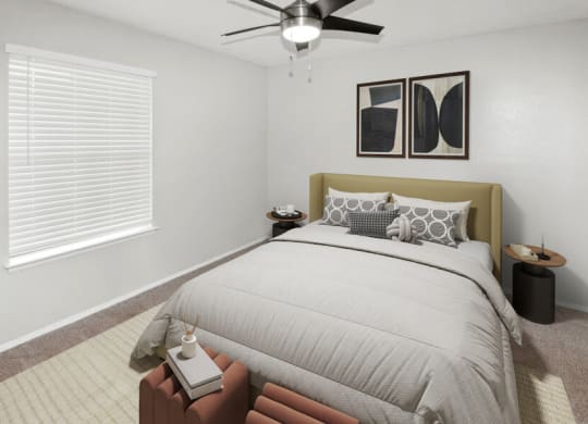 Model apartment bedroom with a bed and a ceiling fan