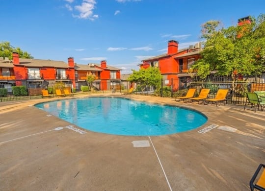 Swimming pool with lounge chairs and cabanas.