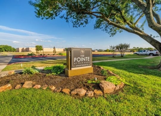 Apartment entrance sign and landscaping