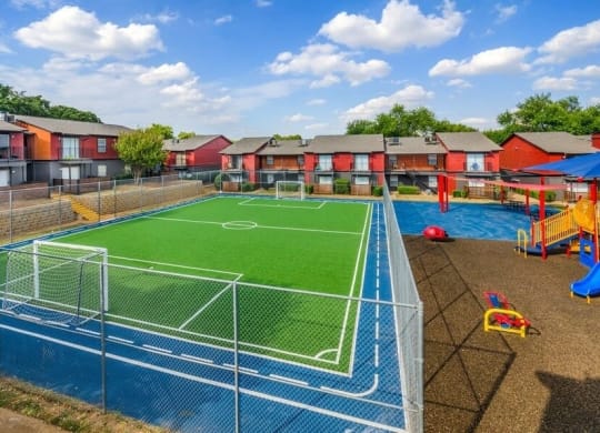 Fenced soccer field and playground  in a courtyard