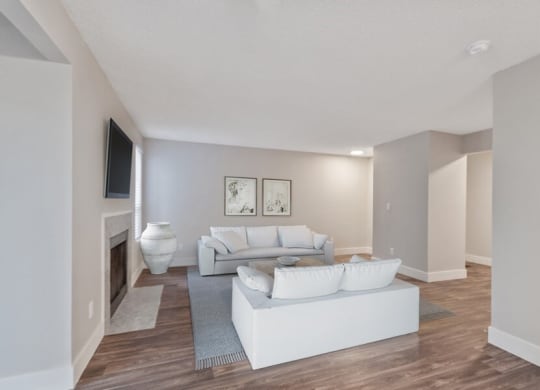 Furnished model living room with wood flooring