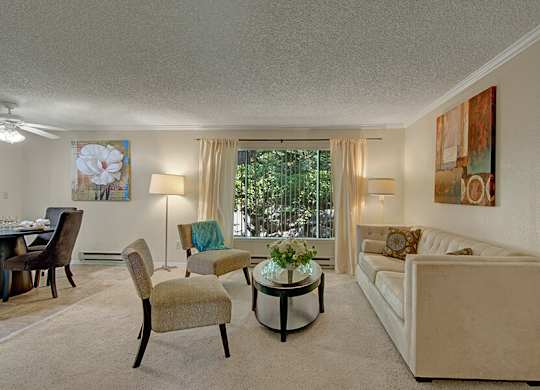 Model Living Room with Patio Accessibility at Ridge & Shores Apartments located in Federal Way, WA.