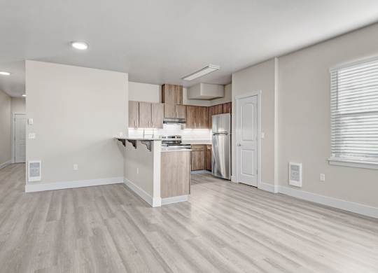 A spacious kitchen with a bar area and a dining table.