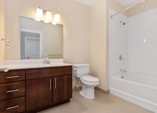 A white toilet sits next to a white sink in a bathroom.