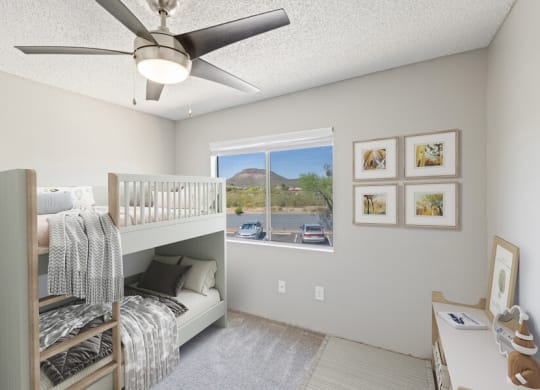 Model apartment bedroom with a bunk bed and a ceiling fan