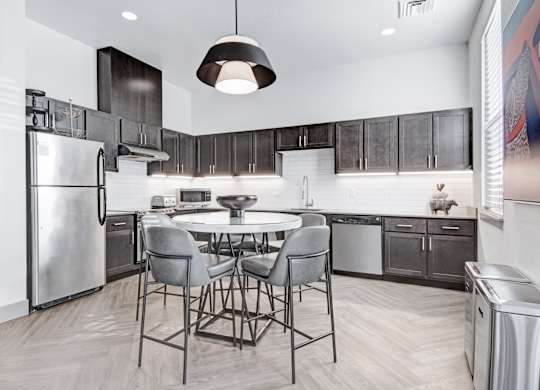 A modern kitchen with a table and chairs.