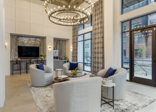 a living room filled with furniture and a large chandelier
