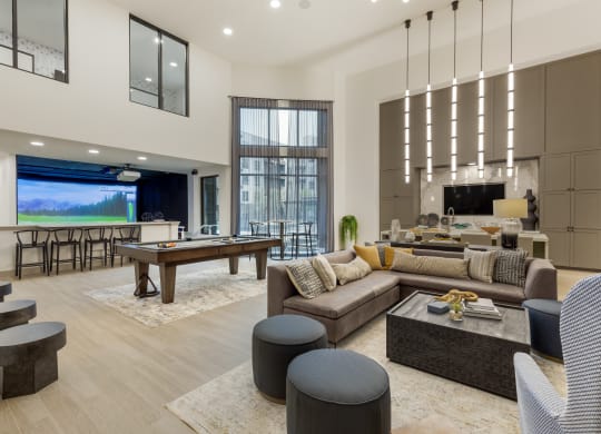 an open concept living room and dining room with a pool table and foosball table