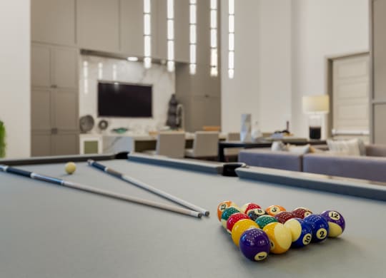 a games room with a pool table and a television