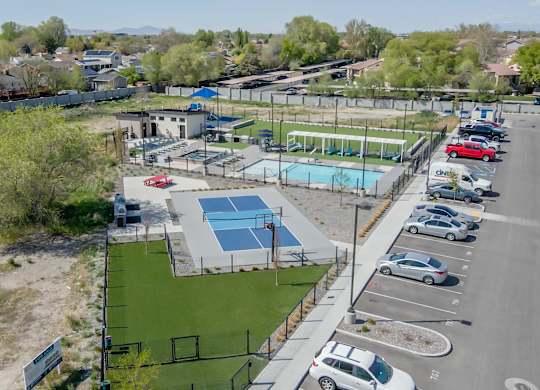 A park with a basketball court, a tennis court, and a swimming pool.