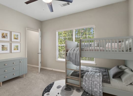 Model apartment bedroom with a bunk bed and a window