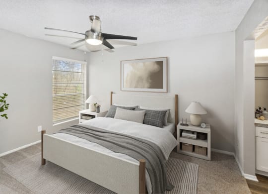a bedroom with a bed and a ceiling fan