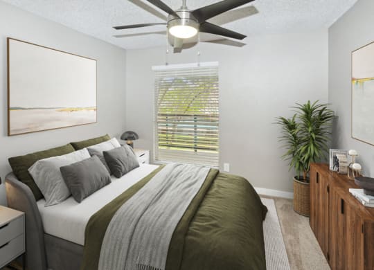 a bedroom with a large bed and a ceiling fan