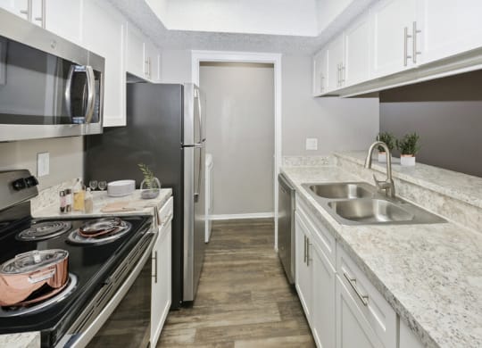 a kitchen with granite counter tops and stainless steel appliances