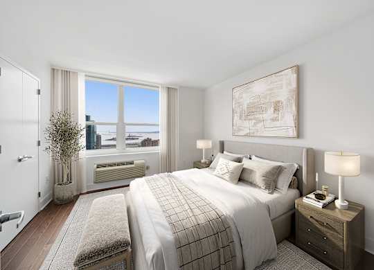 A bedroom with a large bed and a view of the ocean.