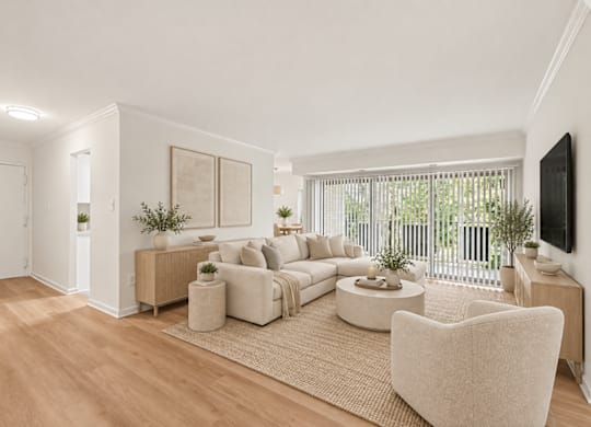 A living room with a white couch and a white chair.