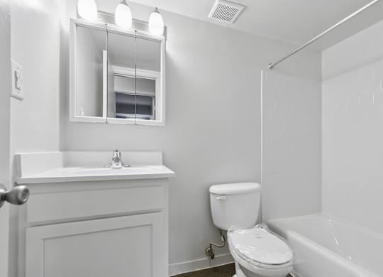 Bright bathroom with white vanity and subway tile at The at Elmwood Terrace Apartments, Frederick, Maryland