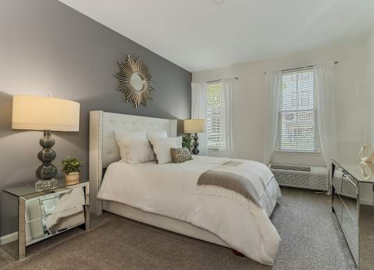 Master bedroom with neutral tones and gray accent wall at Pier Village Apartments, New Jersey, 7740