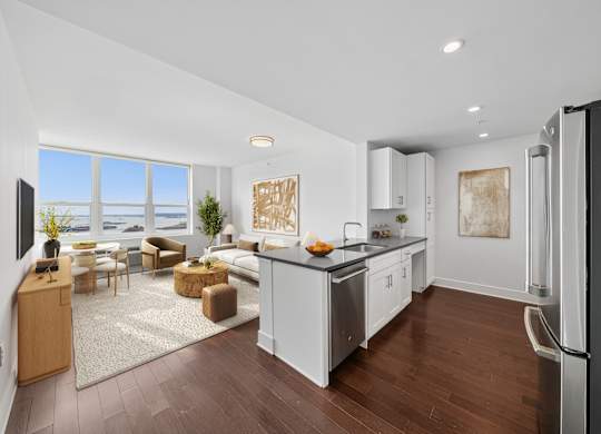 A modern kitchen with white cabinets and a large island.