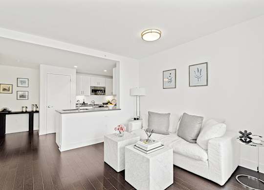 Living room with white couch at 65 Bay Street, Jersey City, NJ, 07302