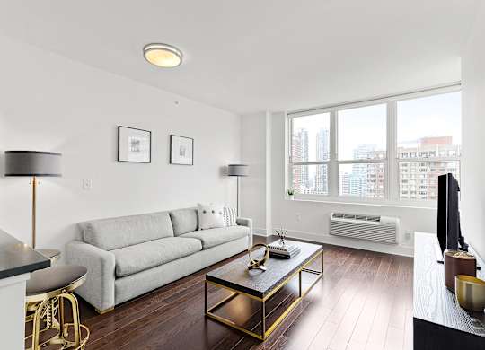 Living room with white couch1 at 65 Bay Street, Jersey City, NJ
