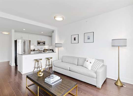 Living room with white couch and table at 65 Bay Street, Jersey City, 07302