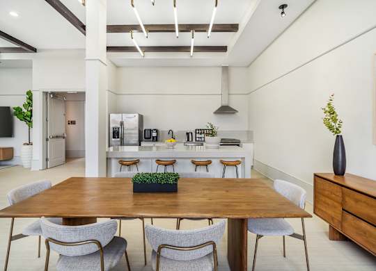 A dining room with a wooden table and chairs at The Addison, Baton Rouge
