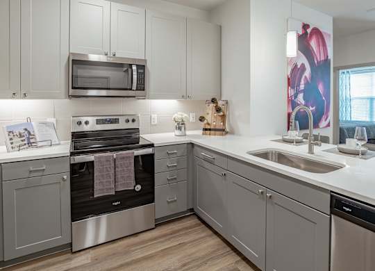 Kitchen with white cabinets at Alys Crossing Apartments, Cypress, Texas