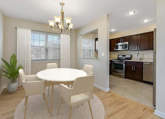 A dining room with a white table and chairs. at Chatham Hill, New Jersey, 07928