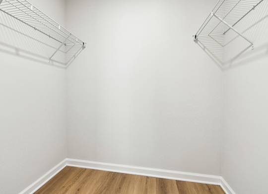 Empty room with white walls and wooden floor.
