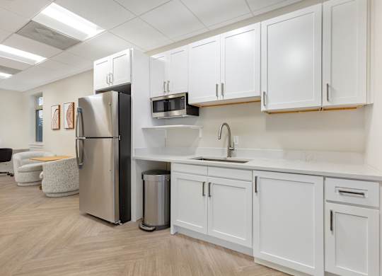 a kitchen with white cabinets and a stainless steel refrigerator at Copper and Quarry Village, Pikesville, MD, 21209