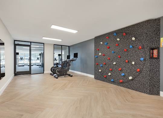 a rock climbing wall in a lobby with a chair at Copper and Quarry Village, Maryland, 21209