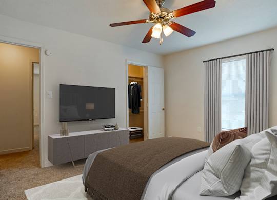 Bedroom with bed, ceiling fan and light at Crosswinds Apartments, Pearl, MS