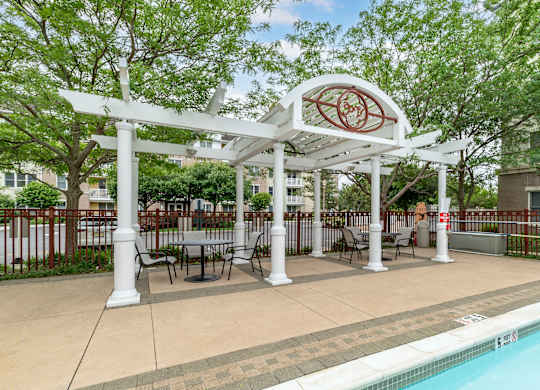 Poolside pergola with outdoor seating area at Pier Village Apartments, Long Branch, New Jersey