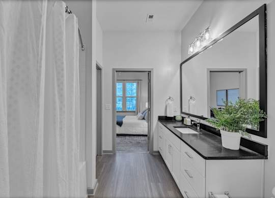 A Bathroom with Large Mirror at District 757 Apartments, Norfolk