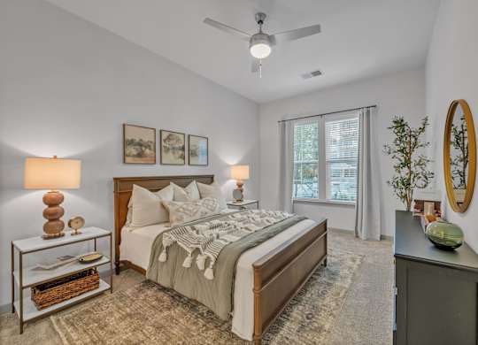 A Bedroom with a Ceiling Fan at District 757 Apartments, Norfolk, VA