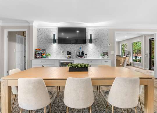 A modern kitchen with a wooden dining table and chairs. at Riverchase Landing Apartments, Hoover, Alabama