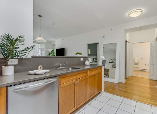 Kitchen with wood cabinets and stainless steel appliances at Pier Village Apartments, Long Branch, 7740