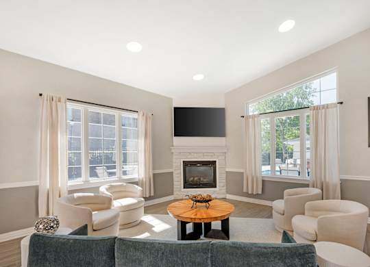 Living room with fireplace and modern furniture at The at Elmwood Terrace Apartments, Frederick, MD
