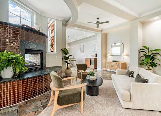 A living room with a fireplace and a couch. at River House Apartments, Norfolk, 23504