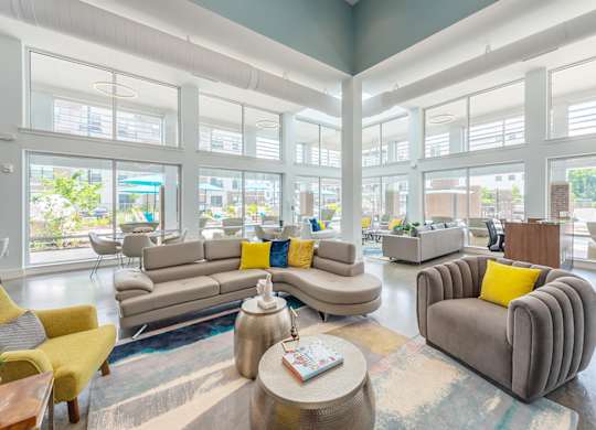 Living room with couch and table at Lumen Apartments, Hampton, VA