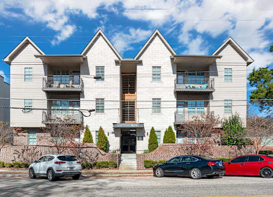 Building Exterior with cars parked at Midtown Row Apartments, Montgomery, 36106