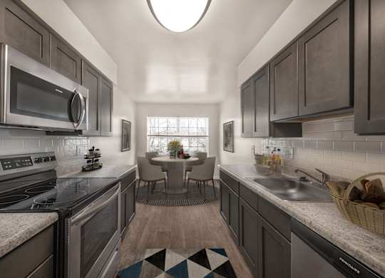 Kitchen with mosaic tiles and cabinets at The Apartments at Owings Run, Maryland, 21117