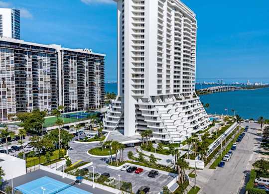 an aerial view of a resort with tall buildings and the ocean at The Hamilton, Miami, 33137