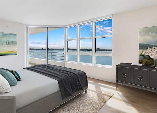 a bedroom with a bed and a view of a body of water at The Hamilton, Miami, Florida