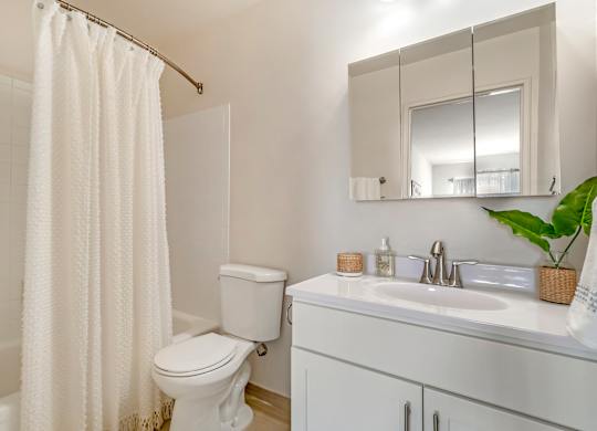 a bathroom with a sink toilet and a shower curtain at Quail Ridge, Plainsboro Township, NJ