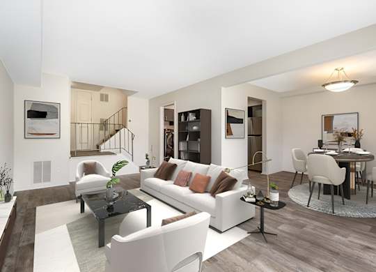 a living room with white couches and chairs and a dining room with a table and chairs at Copper and Quarry Village, Maryland