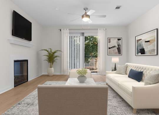 A living room with a white couch, a coffee table, a flat screen TV, and a ceiling fan. at Reflection Pointe, Flowood, 39232