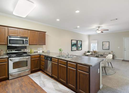 Kitchen with wooden cabinets at Reflections of Island Park Apartments, Shreveport, LA, 71105