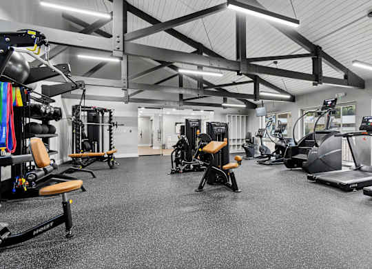 A spacious gym with various exercise equipment.